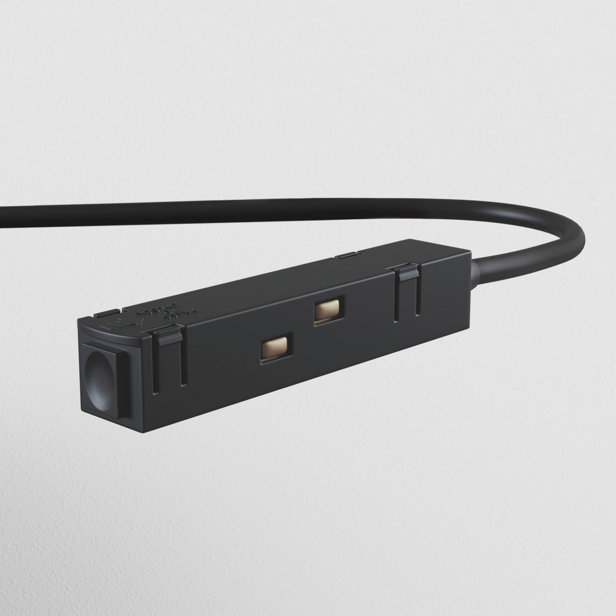Close-up of the S35 Track Power Feed - Black, featuring a thin cable with two metallic contacts and a matte finish, set against a plain white background. This connector is designed for track lighting systems.