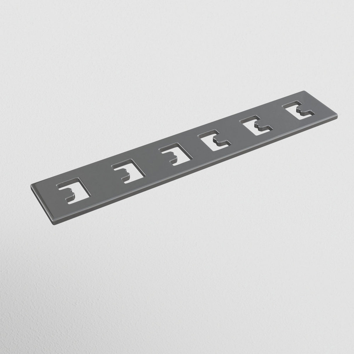The S35 Tracks Recessed Straight Connector in gray metal features five evenly spaced, slightly curved rectangular cutouts, resembling a Linear Track Lighting component, and is set against a white background similar to parts of a magnetic track system.