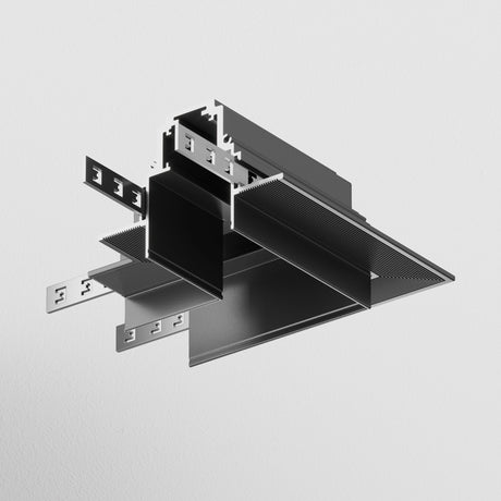 The S35 Tracks Recessed L-Shape Corner Connector in black, boasting a metallic architectural design with interlocking sections and grooves, is suspended against a light gray background. Its industrial and geometric form is perfect for modern interiors.