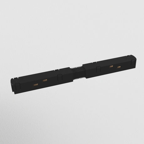 The S35 Track Straight Power Connector - Black is a rectangular electrical component with a ribbed center and connectors at both ends, designed for magnetic track lighting systems. It has small square side openings and is set against a plain white background.