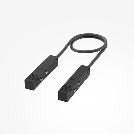 Two sleek black Exility Track Flexible Corner Power Connectors, each 50cm with buttons and ports, are linked by a short looped cable and showcased against a white background, perfect for track lighting installations.