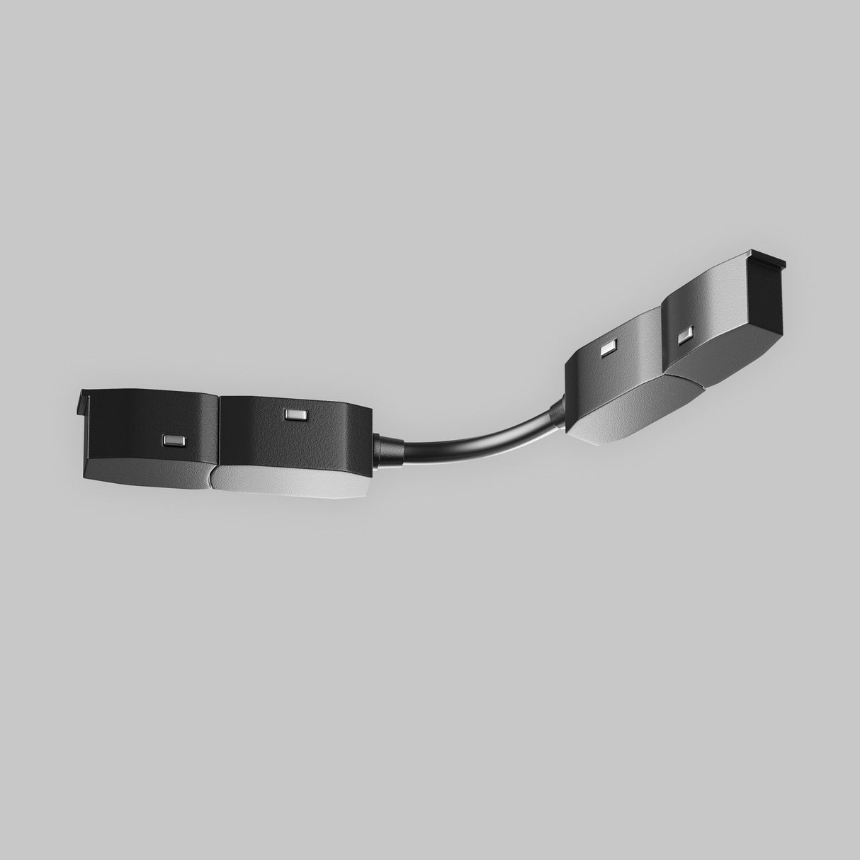 A modern, minimalist ceiling light fixture features a curved design with black and silver rectangular panels on a sleek arm. It integrates an Exility Magnetic Recessed Track Corner Oval Connector - Black, set against a light gray background.