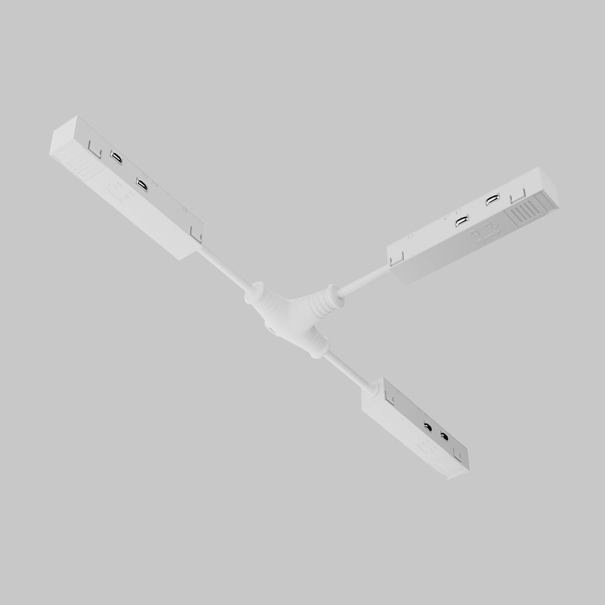 A white, three-arm USB hub, similar to the Exility Tracks Magnetic T-Connector Power Feed, sits on a light gray background. Its minimalist design with multiple USB ports suits multi-directional layouts or Exility magnetic track lighting systems.