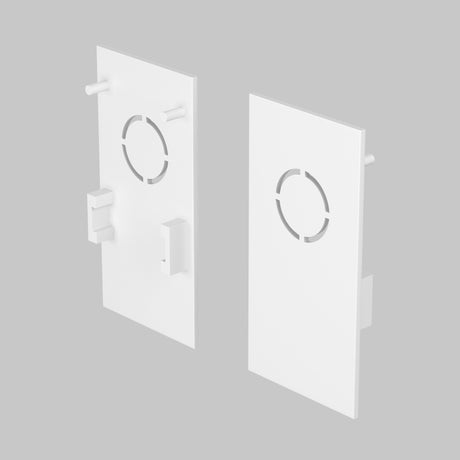 Two white rectangular end caps with circular cutouts and tabs, designed for the Exility Magnetic Surface-Mounted Track lighting system, are displayed from various angles against a gray background.
