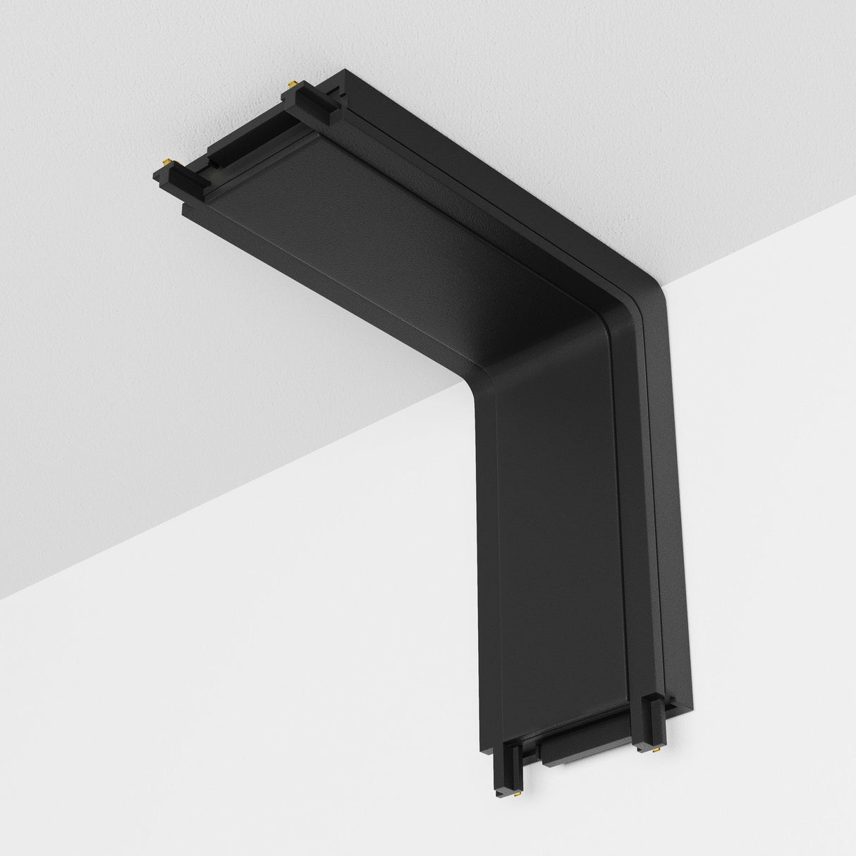 The Radity Magnetic Track Power Connector Internal in black, with a right-angle wall-mounted design, seamlessly integrates into a white ceiling, enhancing your magnetic track lighting system.