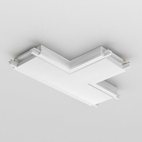 The Radity Magnetic Track T-Shaped Power Connector in white boasts a modern, angular design with layered panels and gold corner accents. Its minimalist look complements sleek interiors and fits perfectly against a plain white ceiling.
