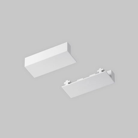 Two white textured rectangular objects appear against a gray background. The top one showcases the Radity Magnetic Surface-Mounted Track, while the bottom has an end cap with small protrusions along one edge, both in sleek white.