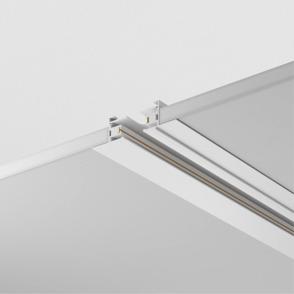 Close-up of the Unity Single Phase Recessed Track 2m in white, featuring an aluminum body with a sleek, straight design. The image shows two intersecting rails, emphasizing modern clean lines and metallic connectors against a plain ceiling—ideal for sophisticated track lighting setups.
