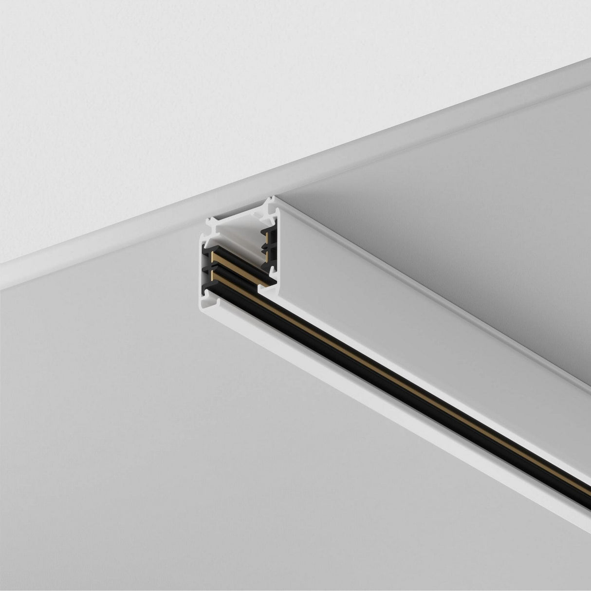 Close-up of a white ceiling featuring the Trinity Three Phase Surface-Mounted Track 2m. The rectangular fixture with open slots for light attachments is seamlessly embedded, offering a modern and minimalist aesthetic.