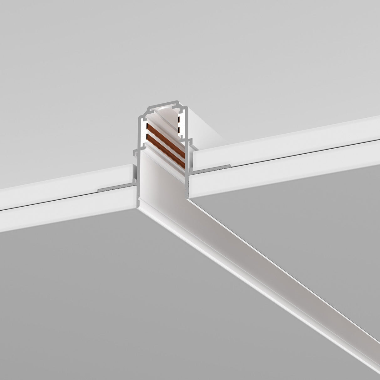 The Exility Magnetic Recessed Track 2m for Plasterboard 12.5mm in white features a T-shaped metal design with visible copper conductors, suitable for customizable 48V lighting setups. Its elegantly set against a gray backdrop to highlight its sleek architectural and electrical elements.