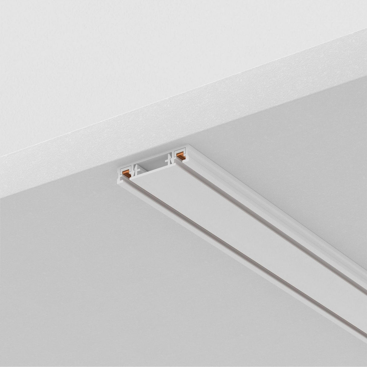 The Radity Magnetic Surface-Mounted Track 1m in white features a sleek design with two exposed copper conductors, providing versatile 48V lighting solutions when installed on flat ceilings.