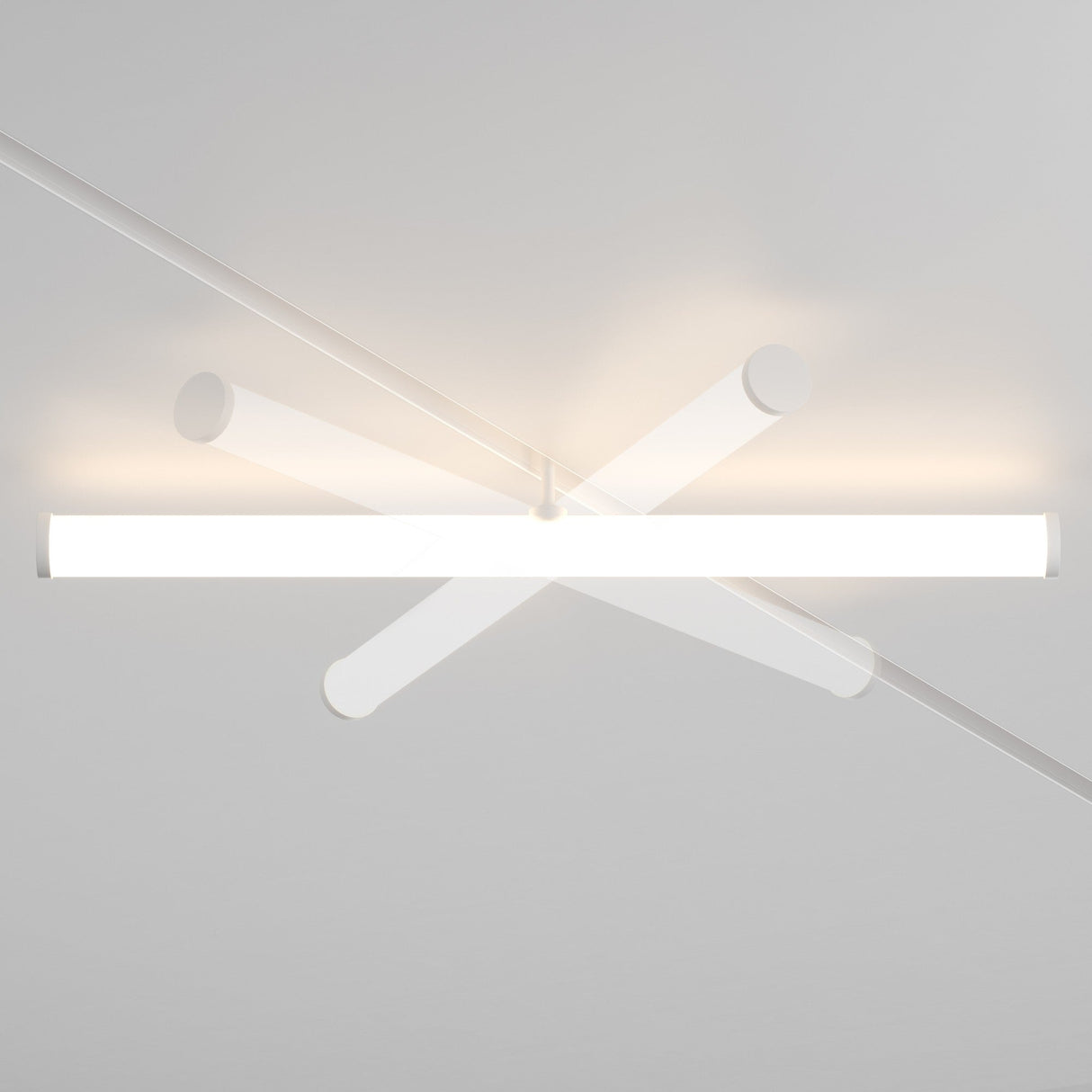 The Larc LED Rotating Linear Track Light for Magnetic Exility (25W, 4000K, White) is a ceiling-mounted fixture with intersecting cylindrical rods and energy-efficient LED lighting that casts a soft, warm glow against the ceiling, creating an abstract geometric pattern.