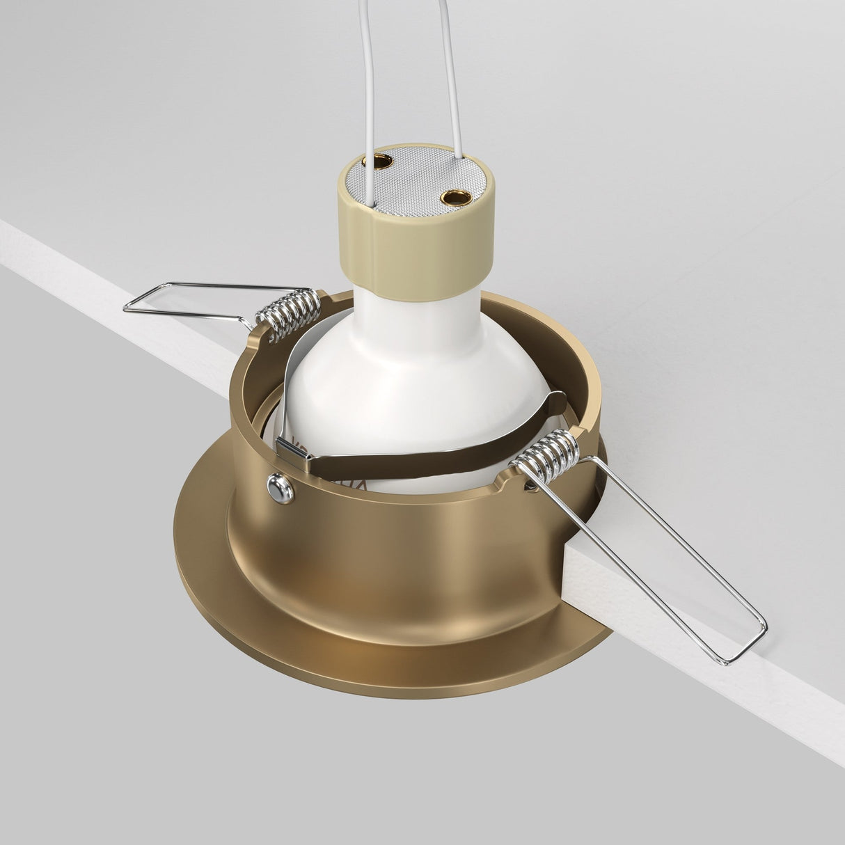 The Slim Fixed Round Recessed Downlight in Matte Gold is displayed in an installation cutout, featuring spring clips and a white bulb holder. It hangs from wires against a white surface, blending style with functionality.