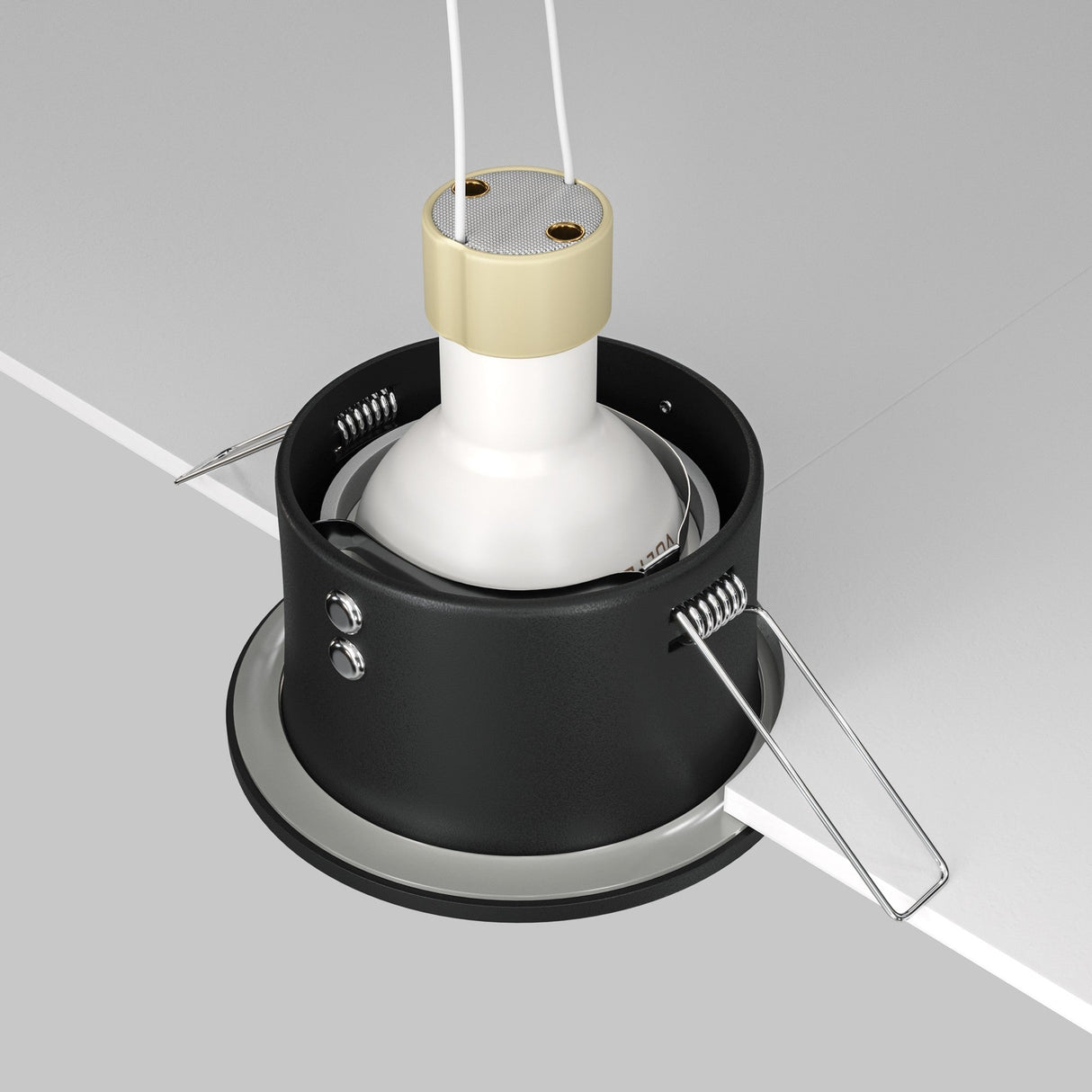 The Zoom Single Fixed Round Recessed Downlight - Black has a high-quality cast aluminium casing with two spring-loaded clips for partial ceiling installation. It includes a white bulb in a beige socket inside black cylindrical housing, with wires extending from the top.