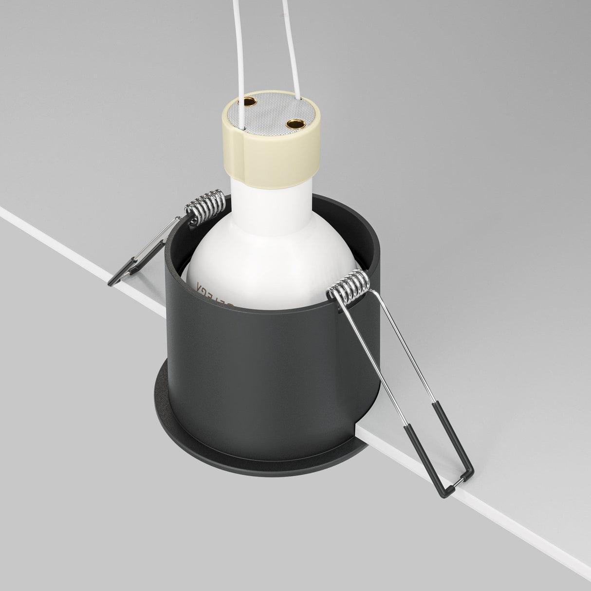 The Reif Round Recessed Downlight - Black is a sleek cylindrical fixture partially embedded in the ceiling, featuring a matte black finish with cream accents. It includes two metal clips for secure mounting and dual wires from the top, providing elegant ambient lighting.