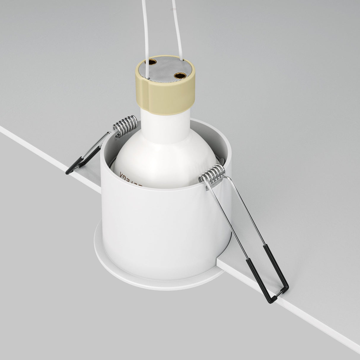 The Reif Round Recessed Downlight - White & Gold is being installed, featuring a white metal housing with elegant white and gold accents. It has spring clips for secure placement and two white wires extending from the beige socket, providing versatile ambient lighting.