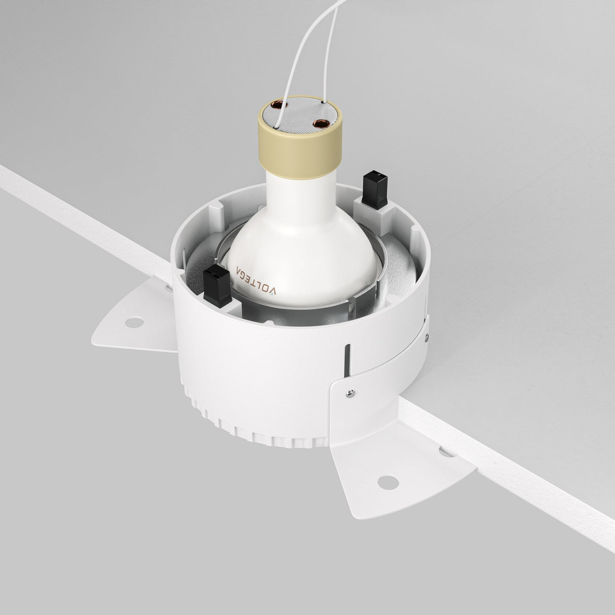 The Share Round Plaster-in Fixed Recessed Downlight in Matte Silver, with two wires and metal brackets, seamlessly integrates into modern ceiling light décor when installed on a flat gray surface.
