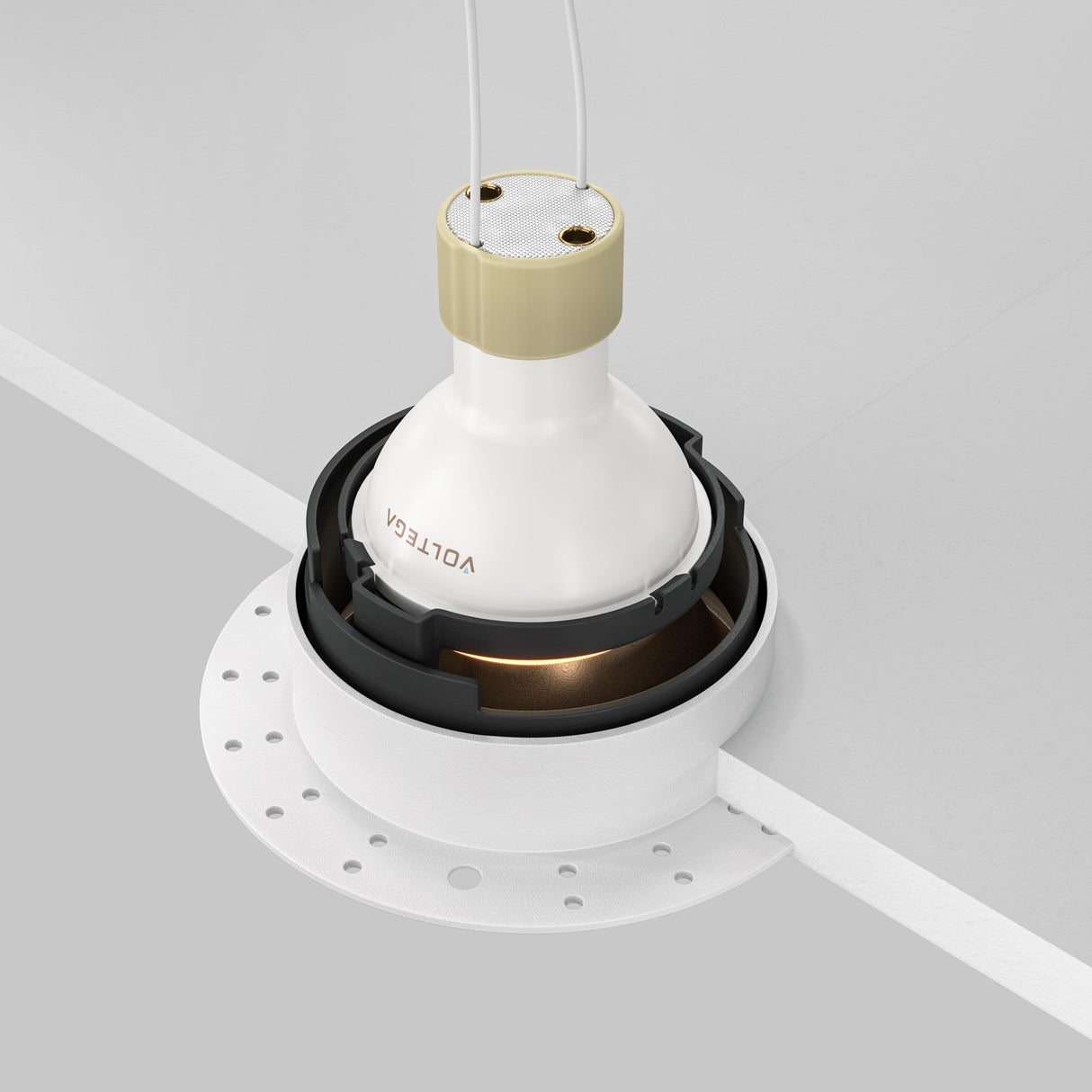 Close-up of a Share Round Plaster-in Recessed Swivel Downlight in white and matte gold. The fixture is embedded in a white ceiling with visible wiring and a circular perforated mounting plate, allowing for adjustable light direction.