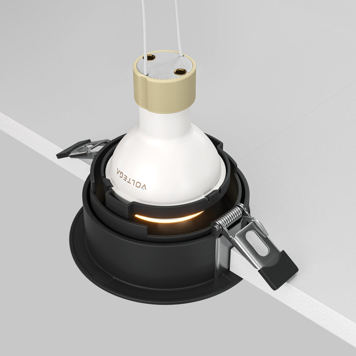 Close-up of a Share Round Recessed Swivel Downlight with a bulb partially inserted into its sleek black housing. It features metal clips, a spring mechanism, and a modern design with white and matte gold accents, prominently displaying VOLTEX on the side.