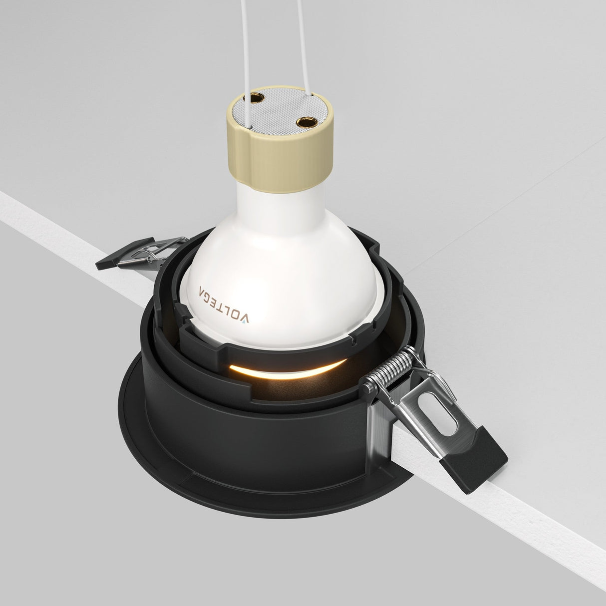 The Share Round Recessed Swivel Downlight in black has metallic clamps for ceiling installation, features a versatile swivel mechanism, and houses a white bulb branded VOLTEG. It includes two wires for easy electrical connection, making it perfect for accent lighting.