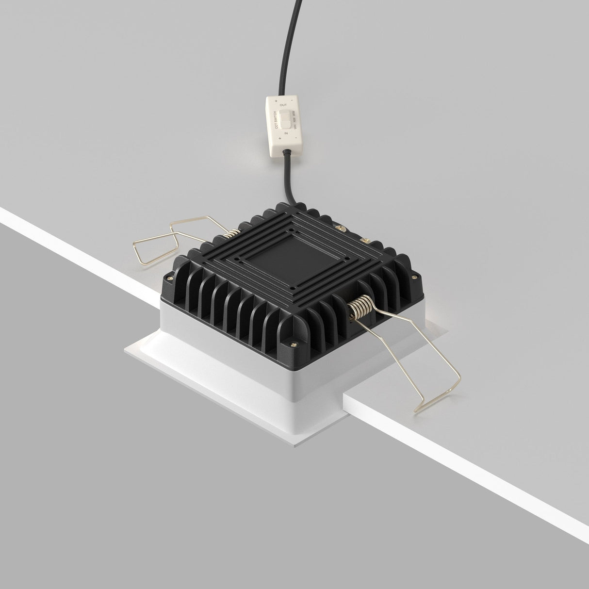The Okno CCT LED Square Recessed Downlight 12W (3000-6000K) in white features a ribbed design mounted on a white surface, with four metal clips and adjustable color temperature. It connects via a power cord with a switch for convenience.