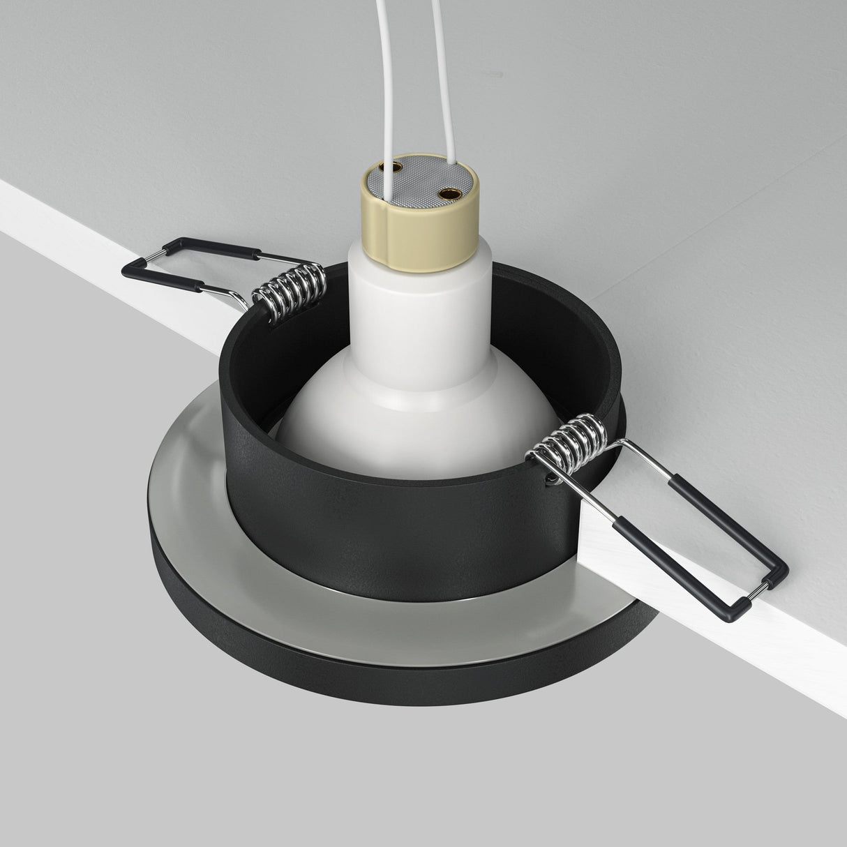 The Stark Fixed Round Recessed Downlight - Black features a close-up of its installation, highlighting a white bulb holder and black bracket with springs. Connecting wires extend through the ceiling cutout, and it supports GU10 bulbs for versatile lighting options.