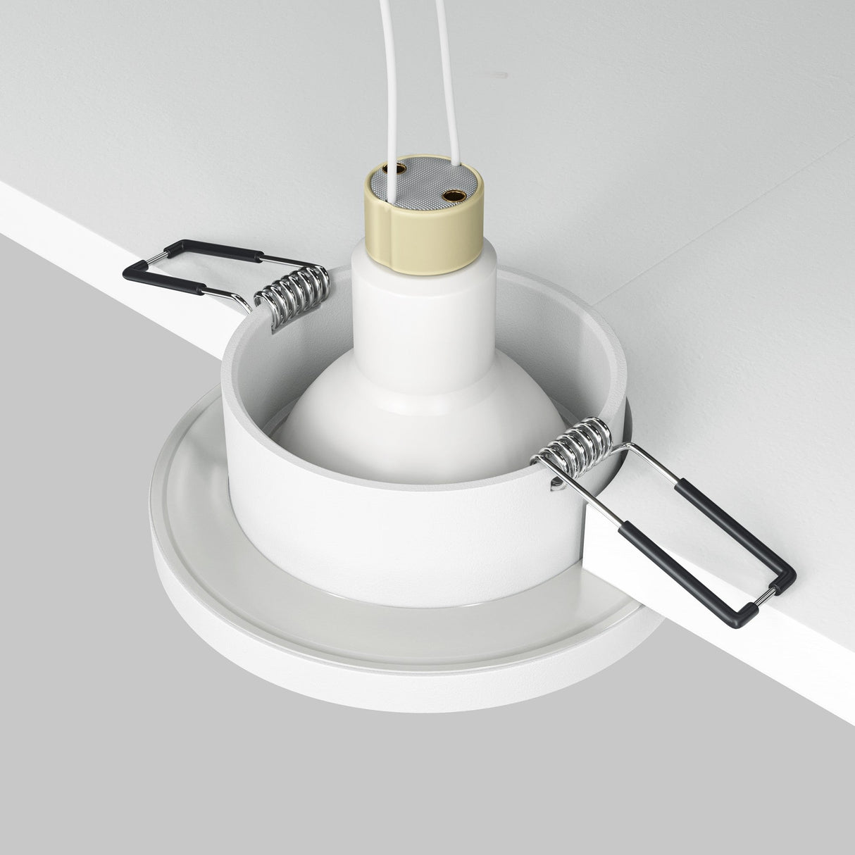 Installing a Stark Fixed Round Recessed Downlight - White in a ceiling, this fixture supports GU10 bulbs and includes a white holder, two metal spring clips, and wiring from the top. It has an IP65 rating for improved durability.