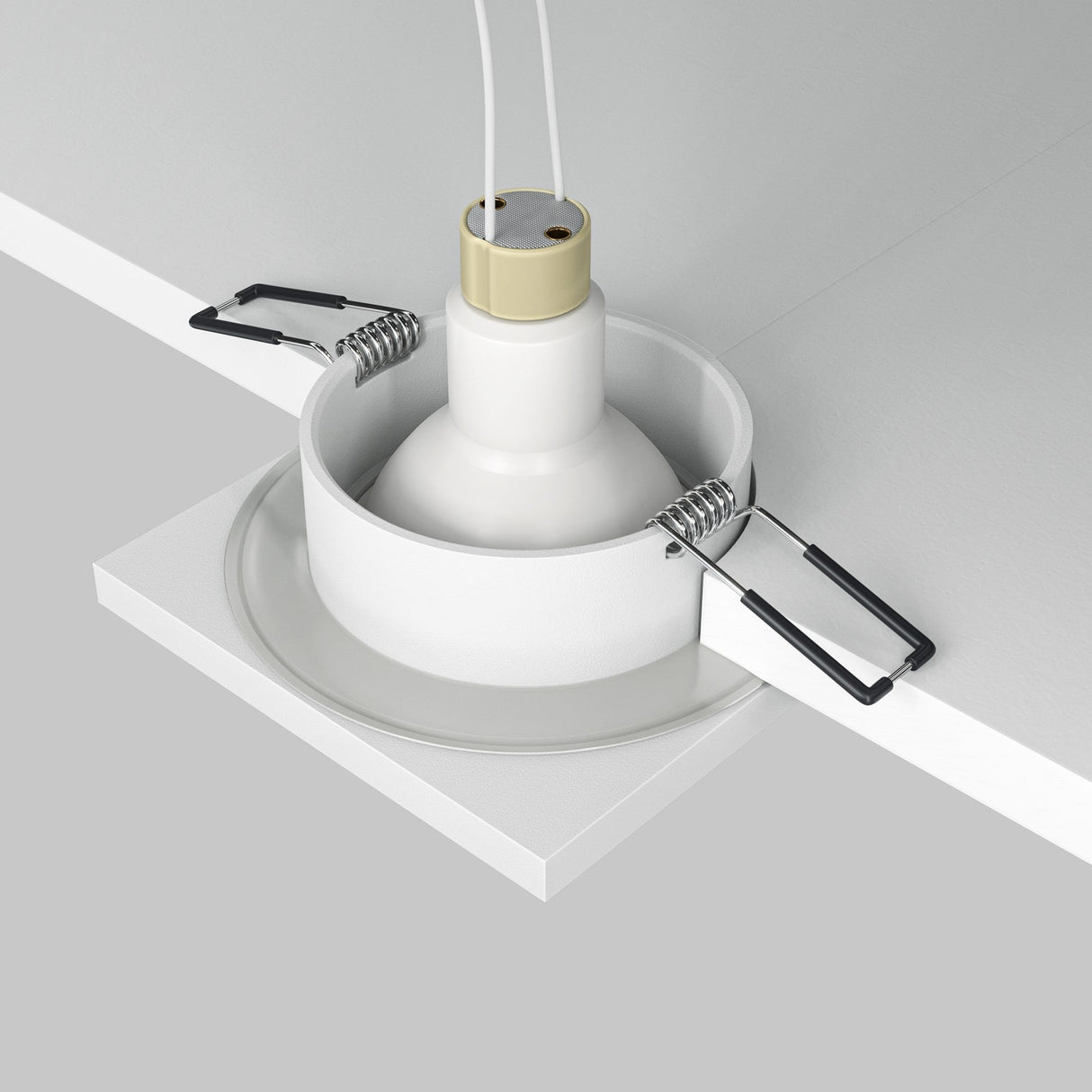 The Stark Fixed Square Recessed Downlight - White is partially embedded in a gray ceiling panel with two metal clips for securing. It features a white base and bulb holder, with no GU10 bulbs installed, offering a clean finish suitable for various lighting needs.