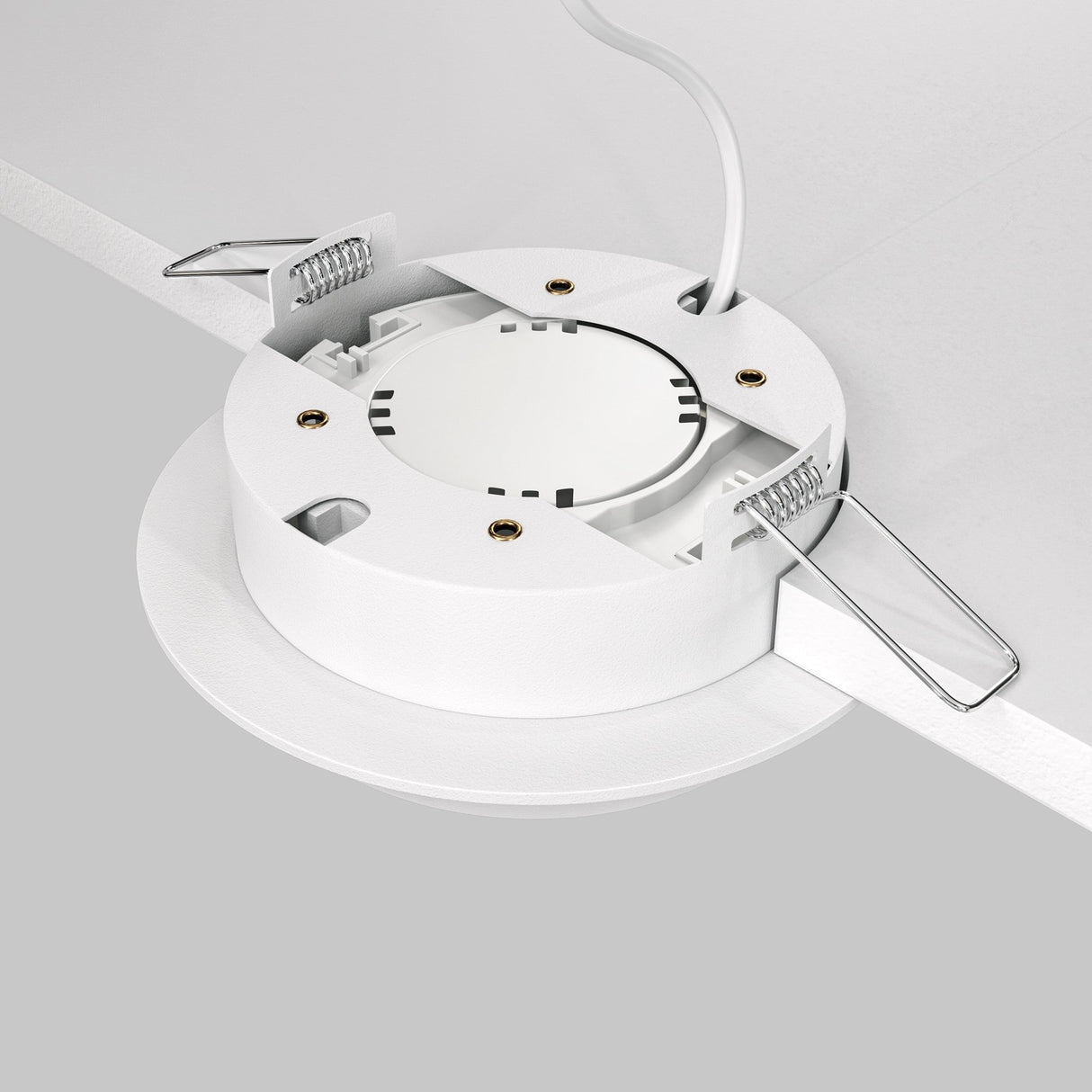 The Hoop Single Fixed Round Recessed Downlight - White features a white housing with metal spring clips for easy mounting. A central white cable offers energy-efficient lighting, shown uninstalled in a partially angled position against a gray background.