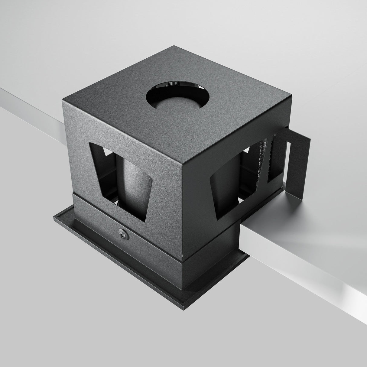 A black Metal Modern LED Square Recessed Downlight 10W 3000K securely clamps a cube-shaped object with a top circular opening to a white surface. Its open sides and minimalistic design reveal the interior, enhancing modern decor.