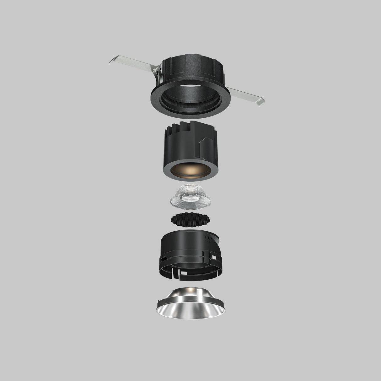 An exploded view of the Wise Downlight Round Honeycomb Light Filter 26mm in black shows its components on a gray background. From top to bottom, the alignment includes outer casing, LED module, lens, heat sink, and reflective trim for glare reduction.