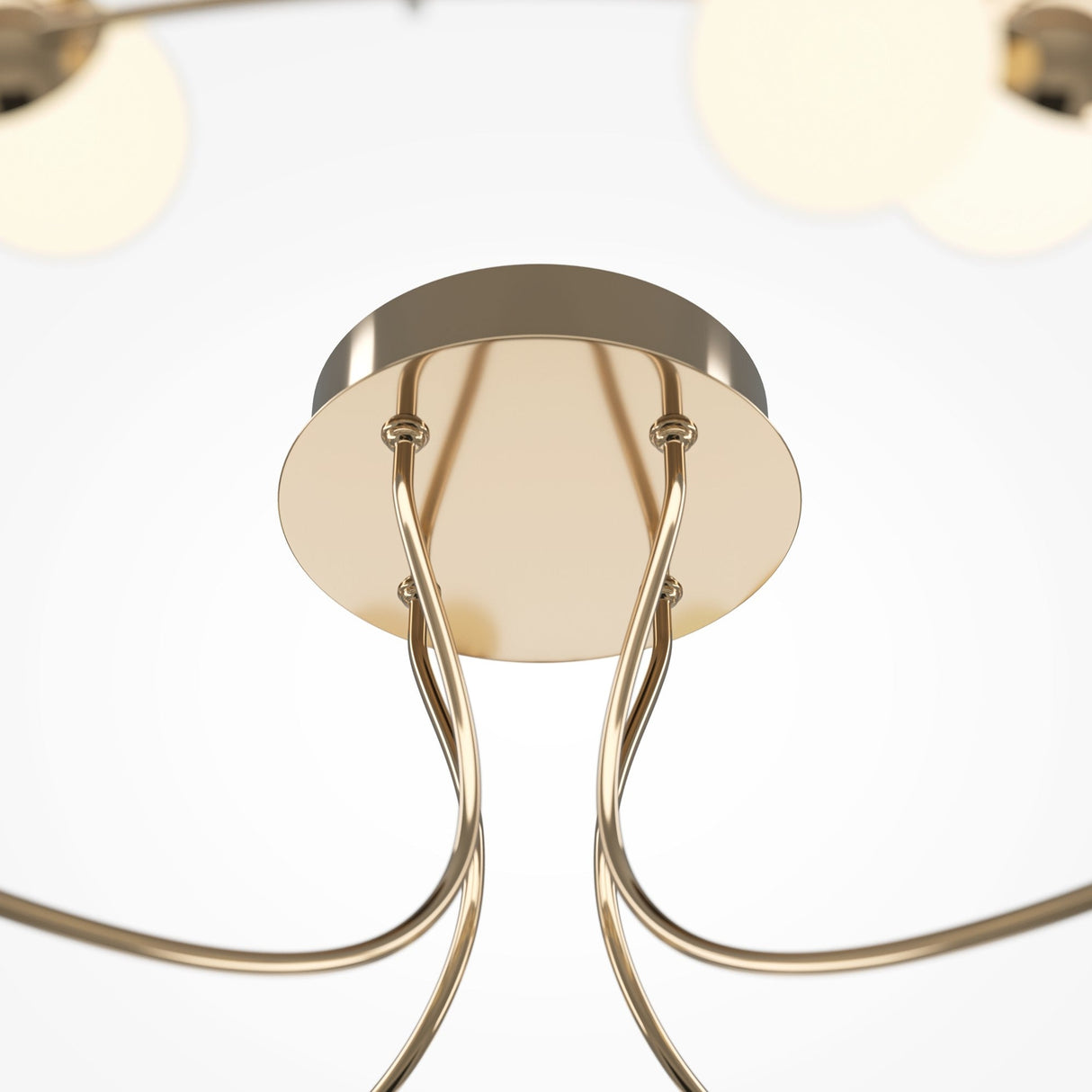 Close-up of the Tessara LED Semi-Flush Light 3000K 55W with a circular metallic base and elegant, curved rods extending downwards. Its minimalist design features an energy-efficient, gold finish, set against a bright, clean background.