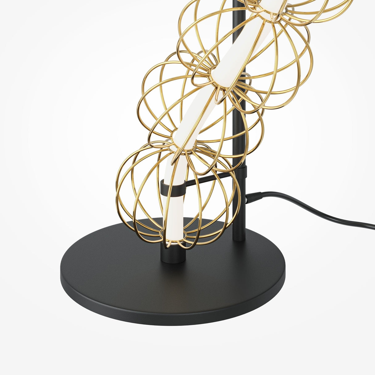 The Golden Cage Floor Lamp - Gold features a modern design with decorative handmade wire spheres around a central white rod. It has a black circular base and plugs in with a black cord.