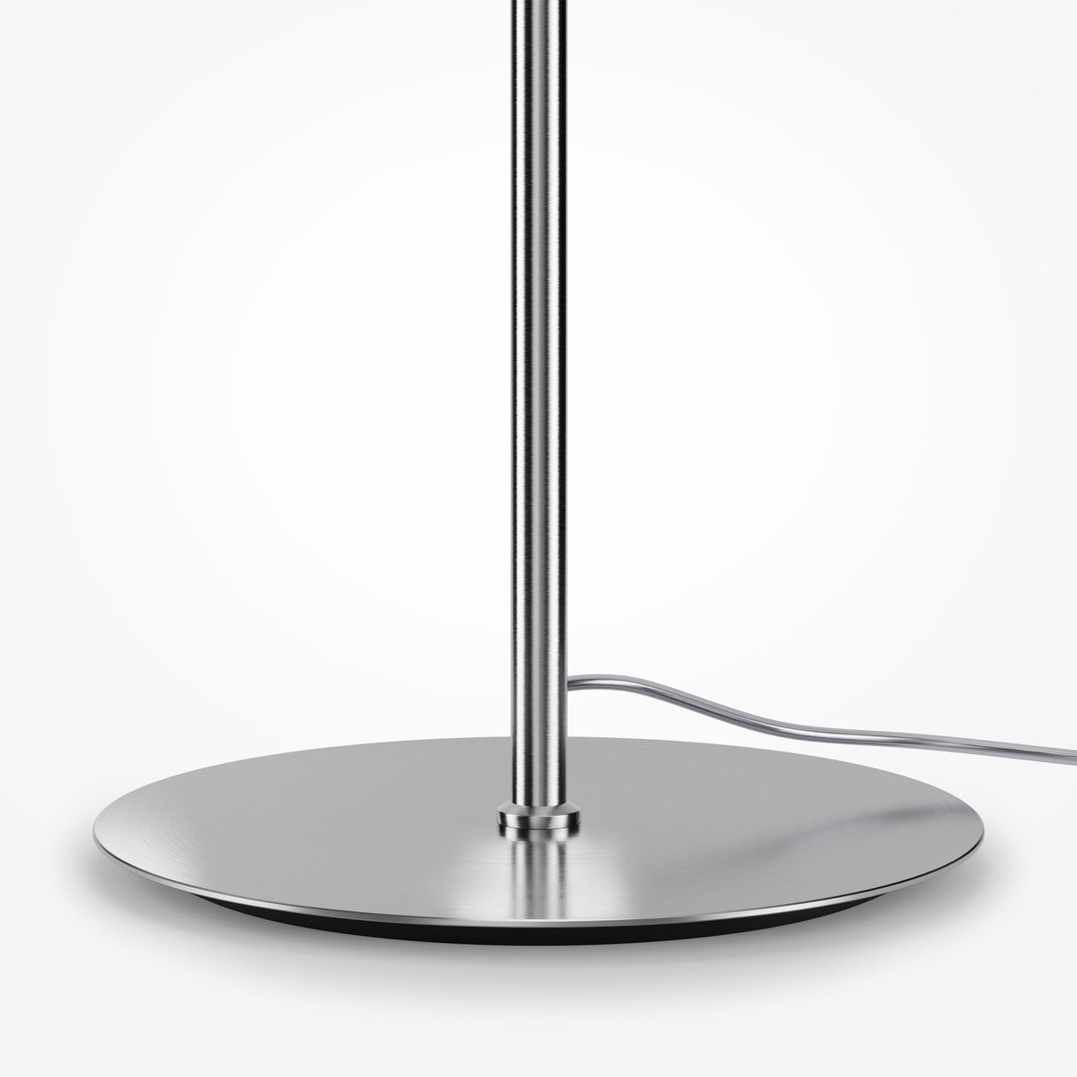 Close-up of the Pattern LED Floor Lamp - Chrome with a sleek metallic base, polished circular stand, and chrome fittings. A power cord extends from the base on a light grey surface. Its modern, minimalistic design emphasizes energy efficiency.