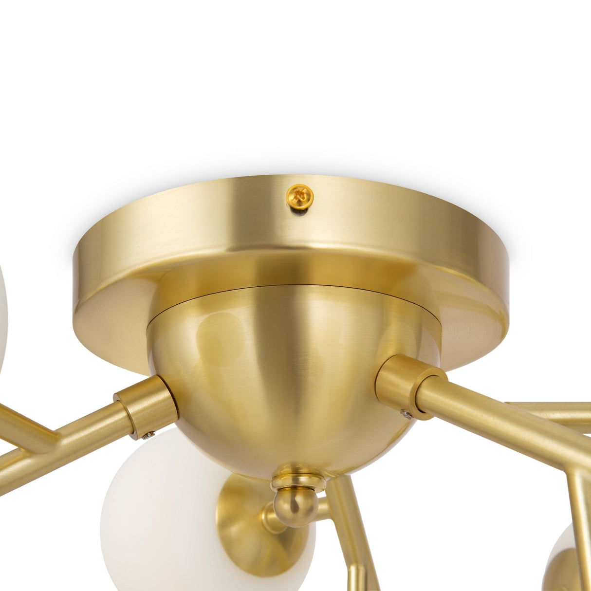 A close-up of the Dallas 12 Light Semi-Flush showcases a modern gold ceiling light with multiple arms extending from a central dome, each holding a round white bulb. The fixture is made of brass with white glass, offering sleek and contemporary lighting.