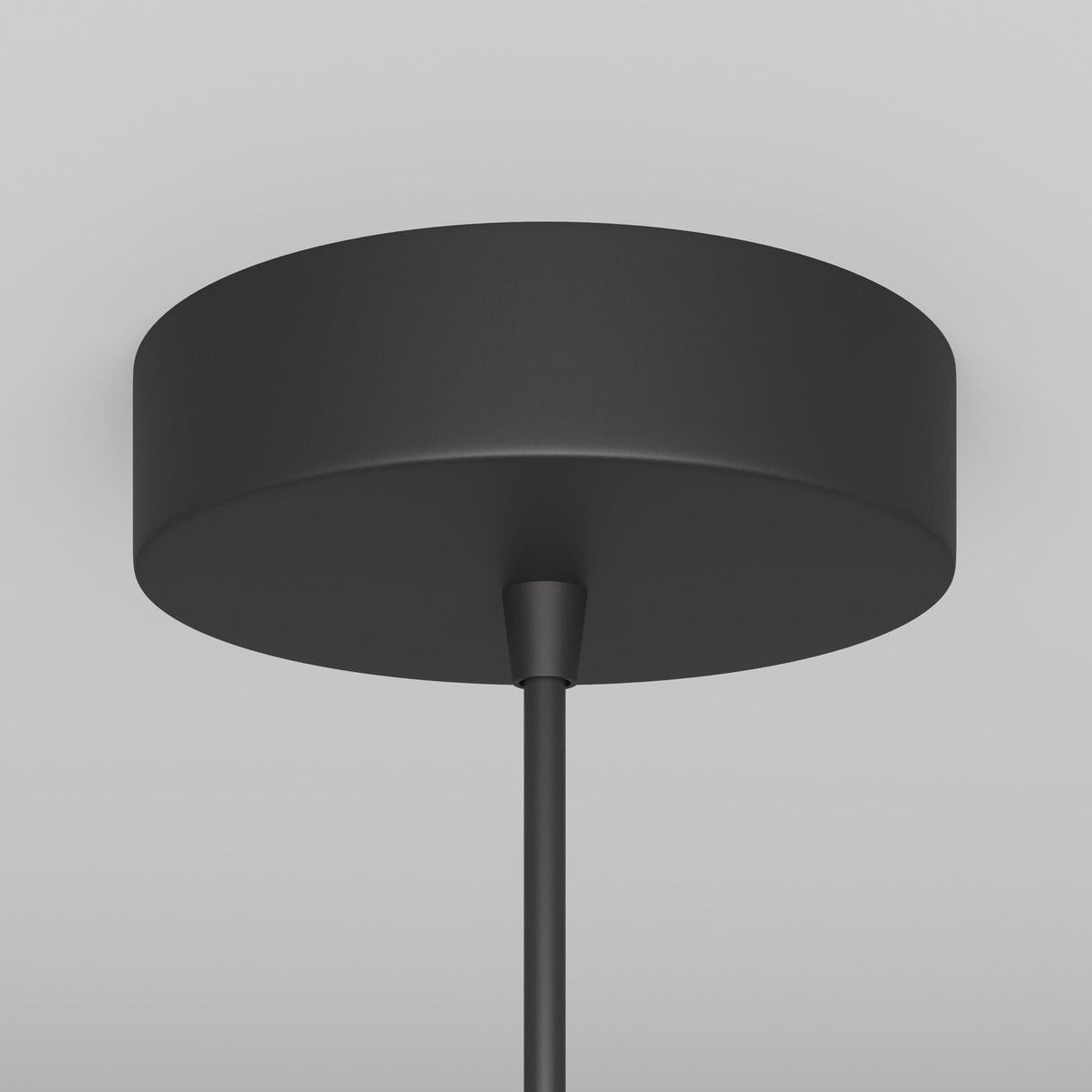 The Arrow 1 Light Long Cone Pendant in black, featuring a minimalist design with adjustable height, is elegantly mounted on a gray ceiling.