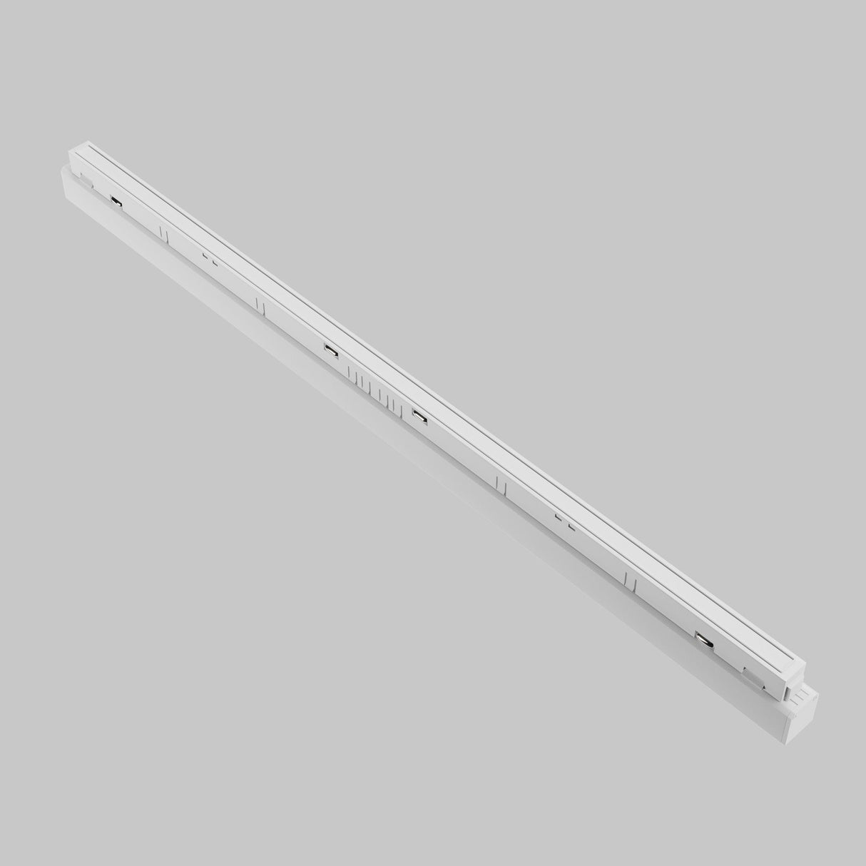 Close-up of a sleek, white Basis CCT LED Dimmable Linear Track Light for Magnetic Exility 24W 2700-6000K on a gray background. Its linear design, grooves, and fixtures ensure smooth operation and seamless integration into any furniture or cabinetry setup.