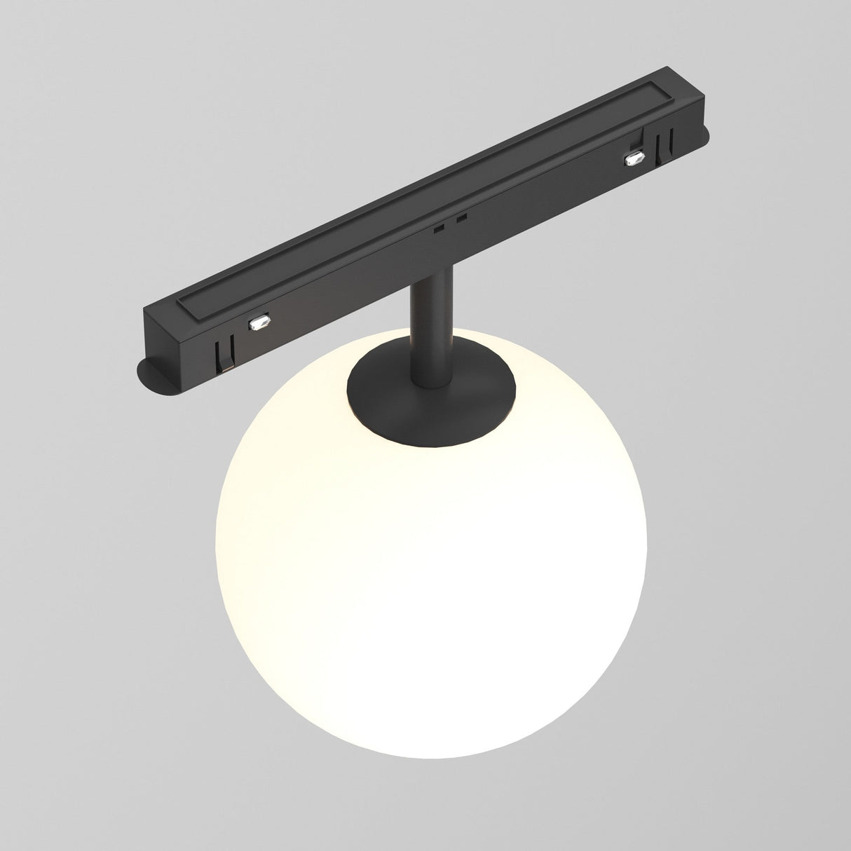 The Luna LED Magnetic Exility Track Globe Ceiling Light 5W 3000K - Black showcases a modern design with a circular white globe suspended from a cylindrical rod on a sleek black base, exuding contemporary elegance against its plain gray backdrop.