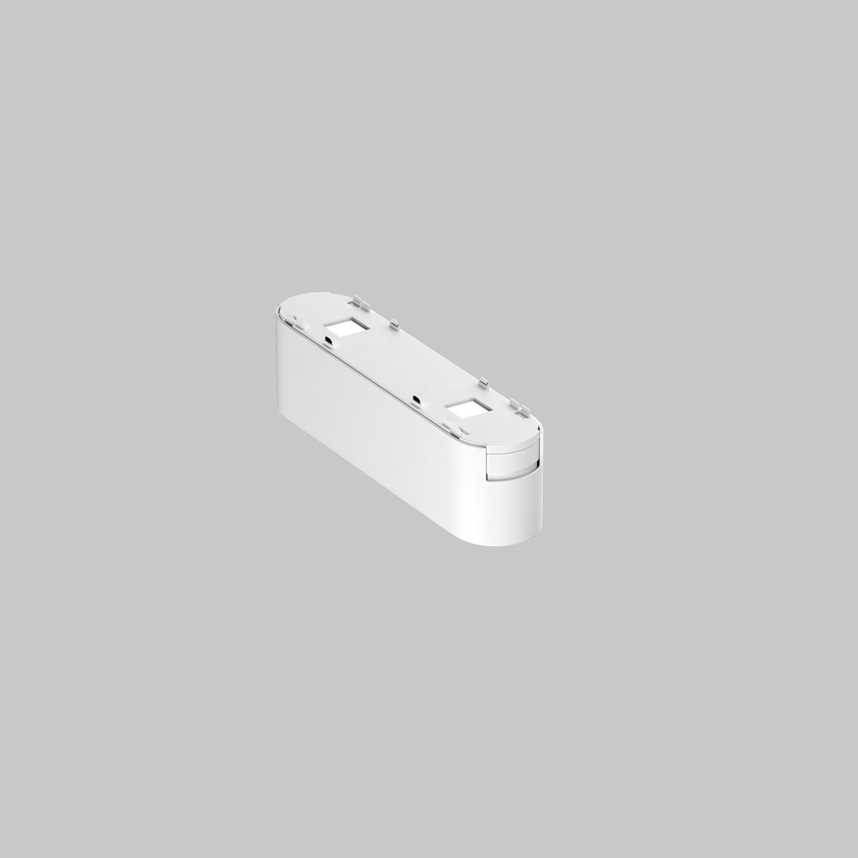 A white rectangular Basis Grid LED Linear Track Light with rounded edges rests on a gray background. Its compact, sleek design suggests a smart home gadget, offering 6W adjustable lighting at 4000K for versatile use on magnetic tracks.