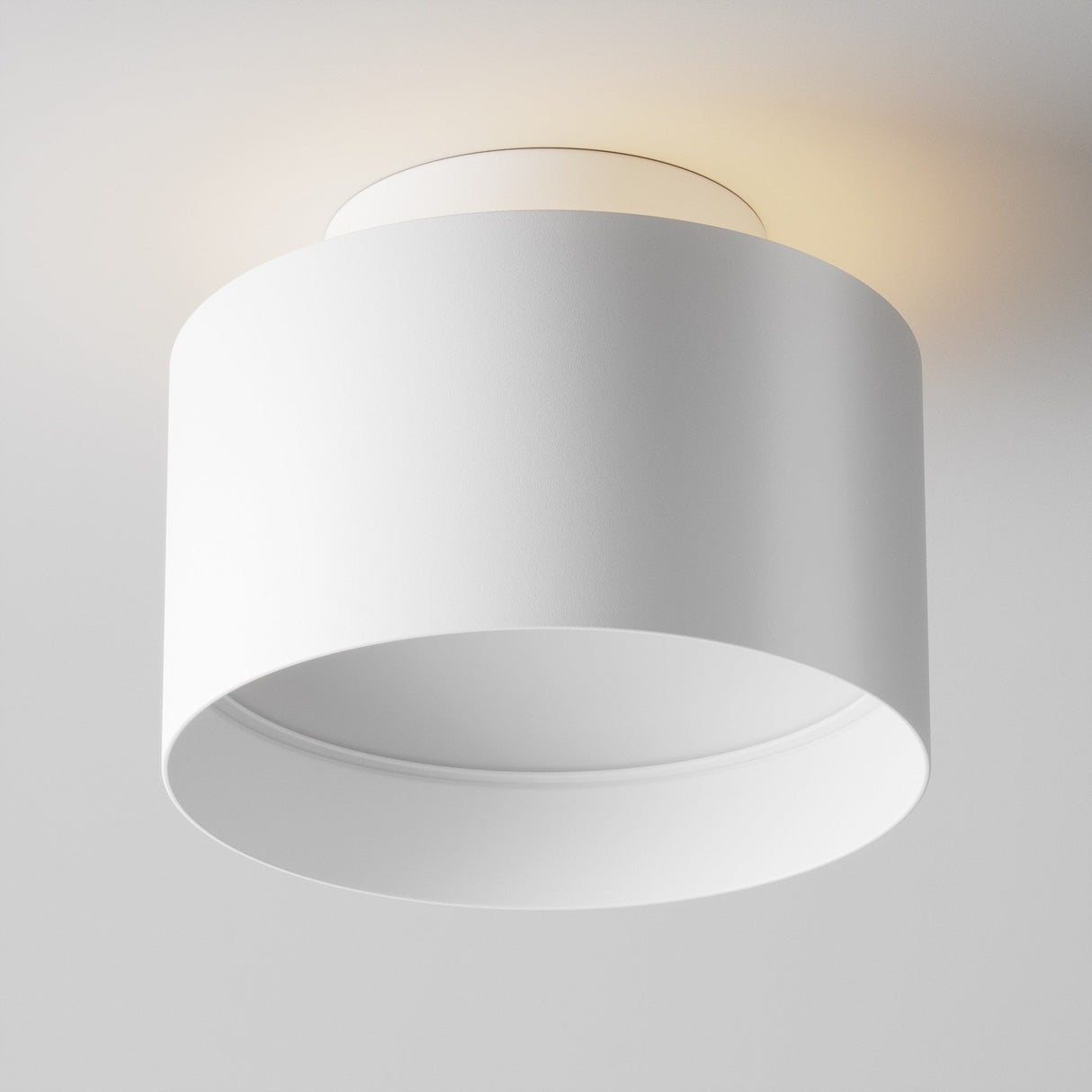 The Planet LED Medium Round Surface Downlight 3000K in white is a minimalist, energy-efficient ceiling fixture thats directly attached. It emits a soft glow, enhancing its modern design while illuminating the surrounding ceiling area.