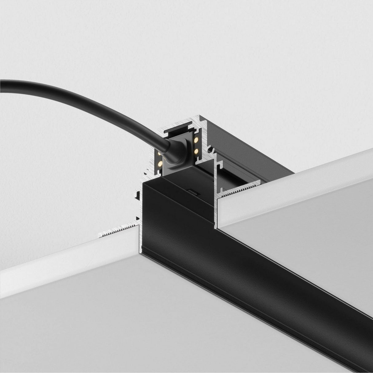 Close-up of a black cable connected to the S35 Magnetic Recessed Track 1m for Plasterboard 12.5mm - Black, highlighting its intricate connections and design details, perfect for customized lighting in plasterboard ceilings.