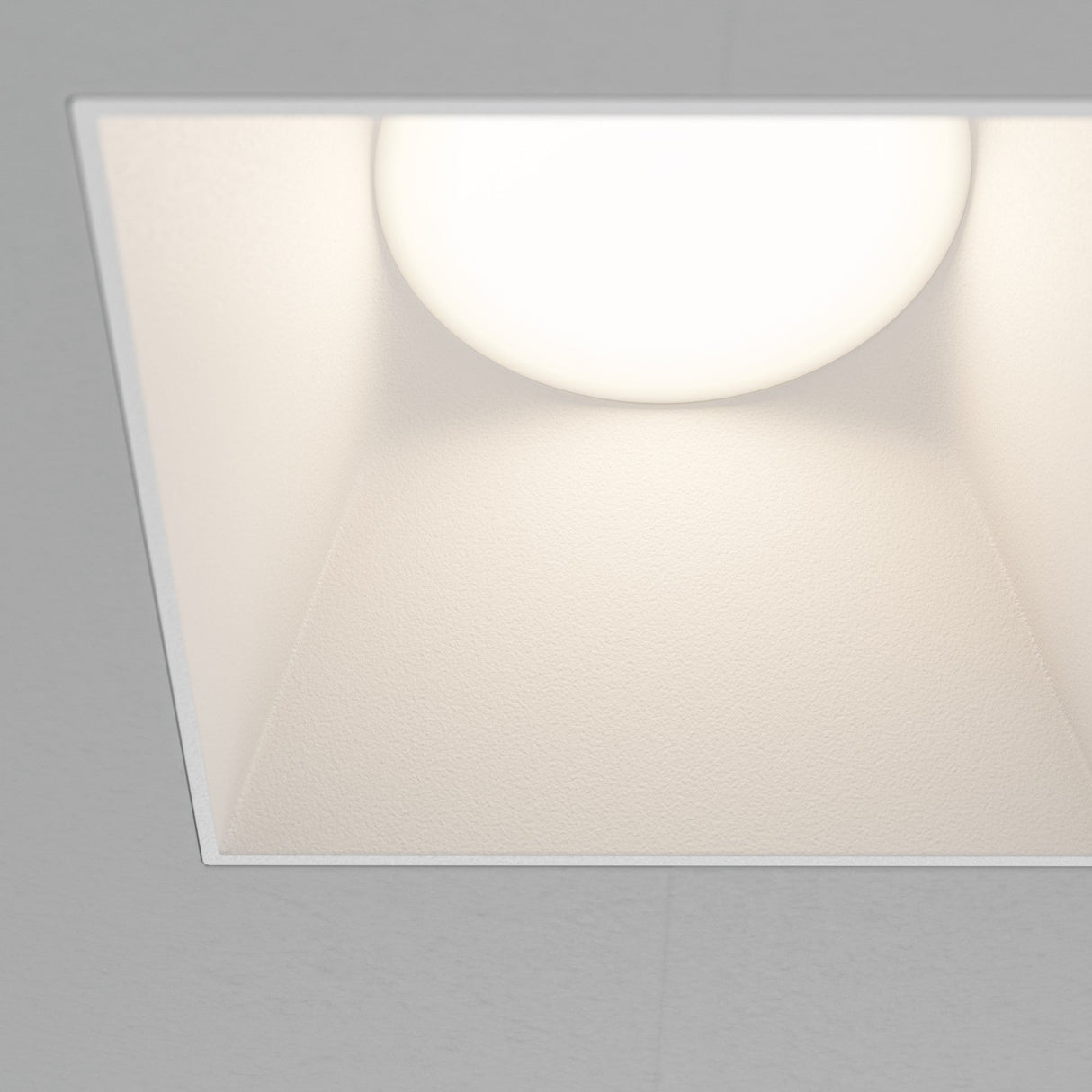 Close-up of Share square plaster-in fixed recessed downlight in white, highlighting its minimalist finish.