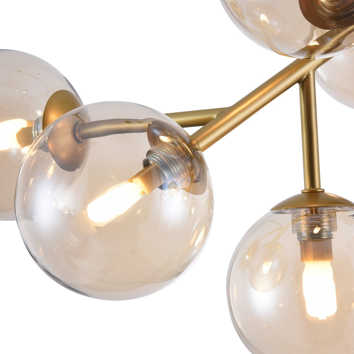 Close-up of a modern chandelier: gold fittings connect amber glass orbs encasing warm bulbs. Its artistic, geometric design mirrors the Dallas 12 Light Semi-Flush - Gold With Amber Glass, showcasing meticulous craftsmanship and intricate details.