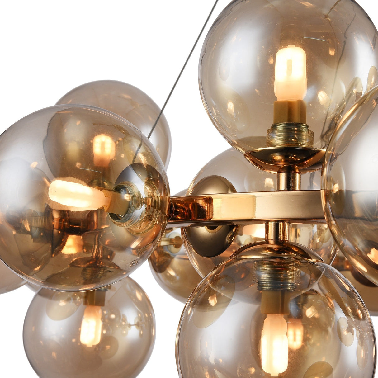 Close-up of the Dallas 25 Light Suspension - Gold With Amber Glass, featuring clustered amber glass globes with visible bulbs. Attached to a golden metal frame, it offers a modern and elegant design.