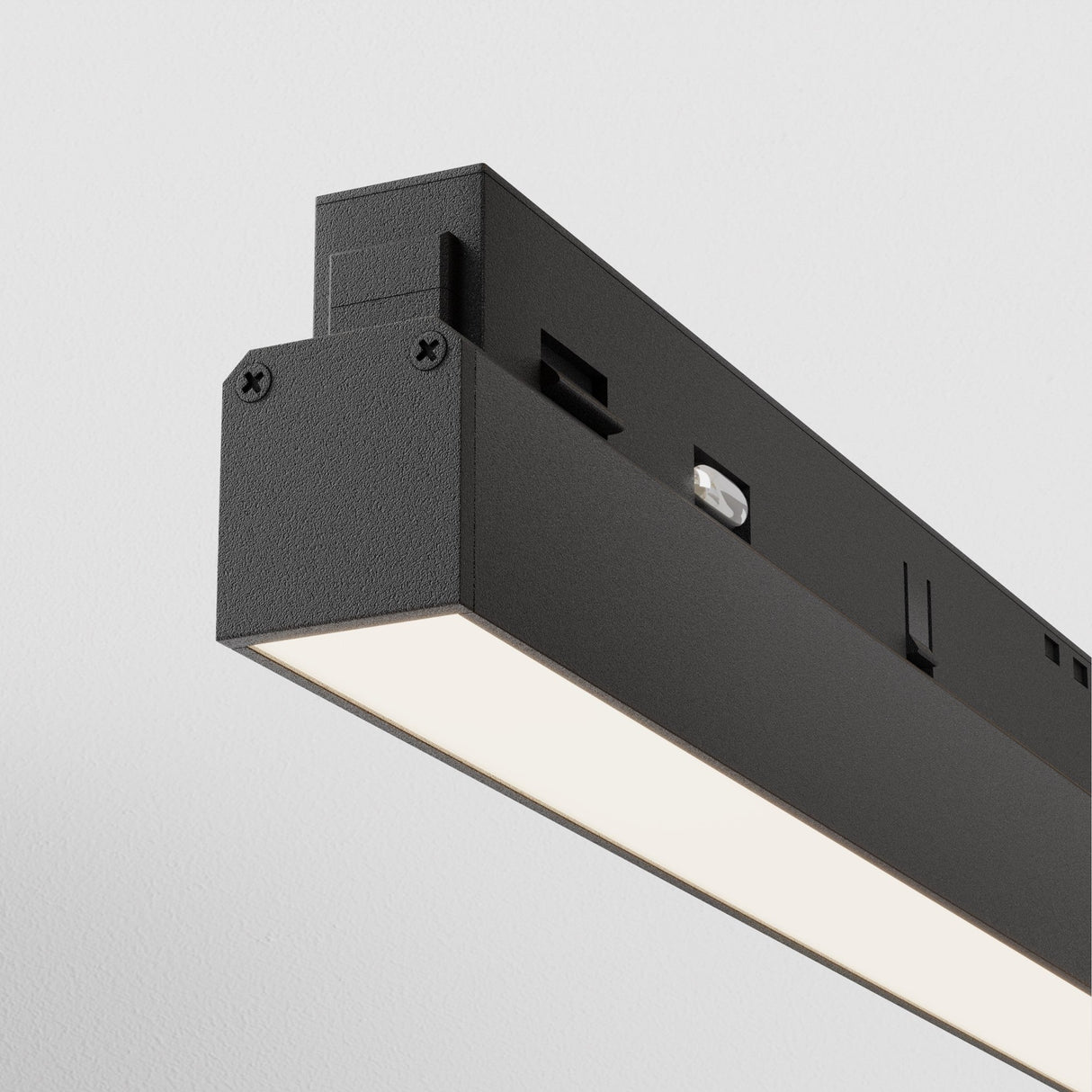 Close-up of the Basis LED Linear Track Light for Magnetic Exility against a plain white background. This modern, rectangular fixture has a 24W, 4000K minimalist design with a textured matte black finish and visible screws and slots on the side.