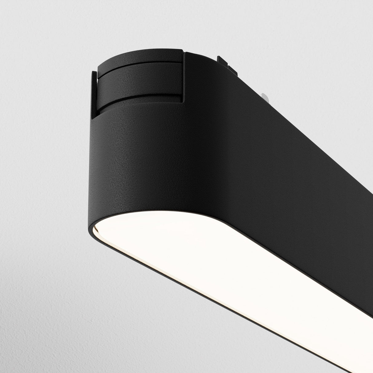 The Basis LED Linear Track Light for Magnetic Tracks Radity 12W 4000K - Black is a sleek, modern ceiling fixture with rounded edges that offers bright task lighting and an even glow, thanks to state-of-the-art LED technology.