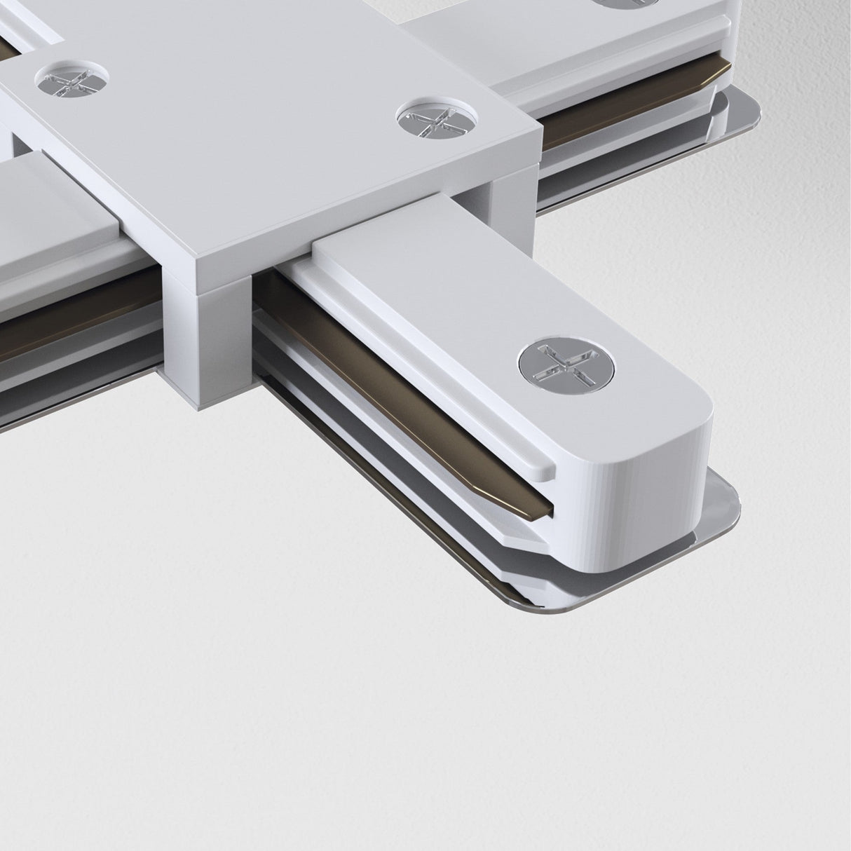 Close-up of the Unity Single Phase Surface-Mounted Track X-Connector in white, with interlocking metallic parts for assembly, highlighted by multi-directional lighting. It features a sleek finish with visible screws and grooves against a light gray backdrop.