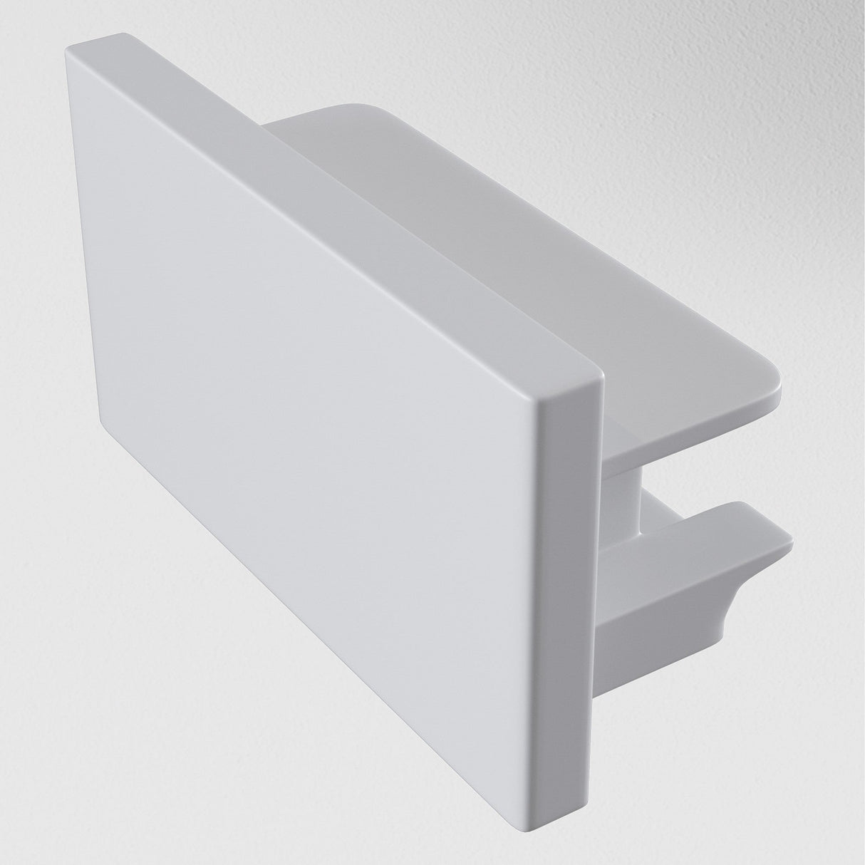 The Unity Single Phase Surface-Mounted Track End Cap - White is a minimalist, rectangular accessory displayed on a light grey background, offering a sleek design for seamless shelf support with modern flair.