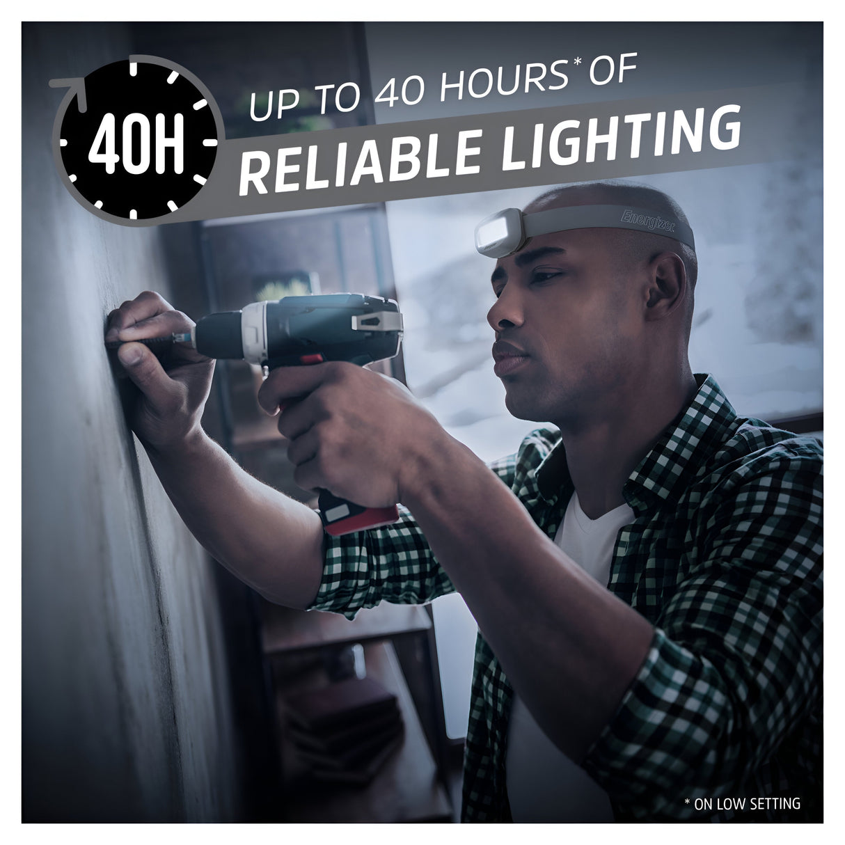 A man, equipped with an Energizer LED Head Torch 400 Lumen - Batteries Included, uses a power drill on a wall. The image underscores the text "Up to 40 hours of reliable lighting," showcasing the headlamp's impressive battery longevity.