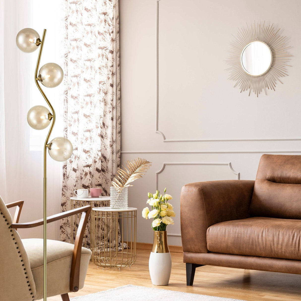 Cosmic 4 light floor lamp in black and brass finish, shown in a room setting